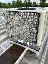 HVAC unit destroyed by large hail, hail damage on commercial roof hvac unit on a business building, austin roofing company, roofing company dripping springs, roof repair westlake, roof replacement lakeway